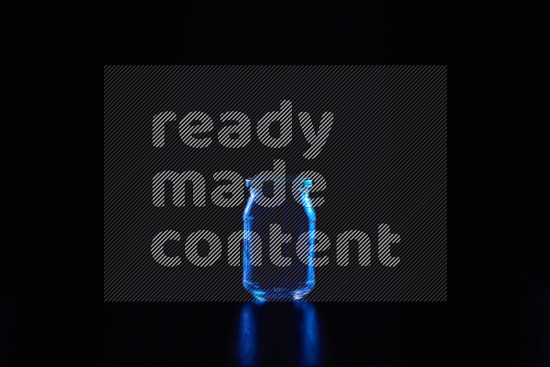 Glassware with rim light in blue against black background