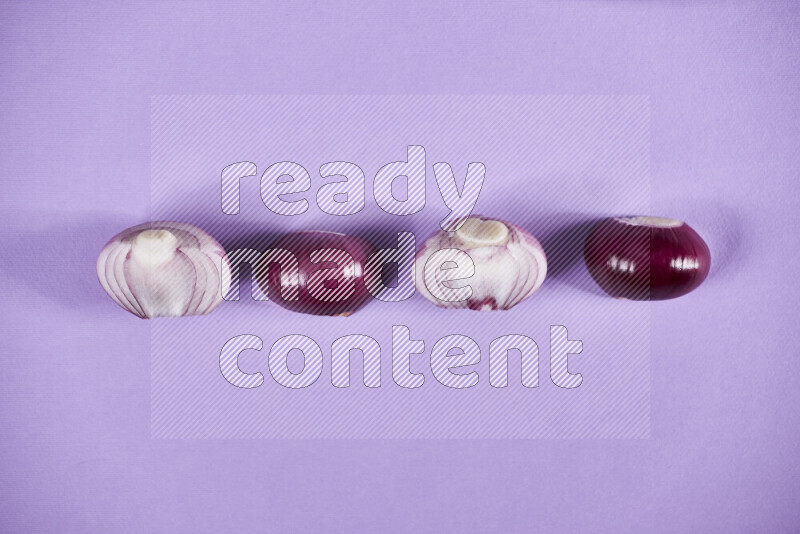 Halves red onions on a purple background