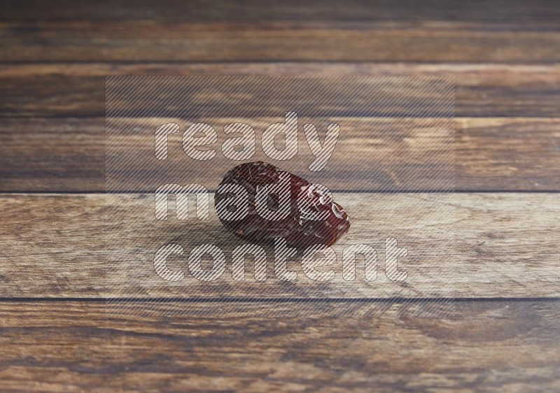 one madjoul date on a wooden background