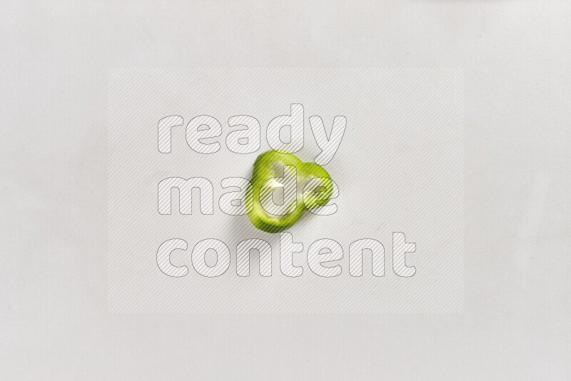 Green bell pepper slices on white background