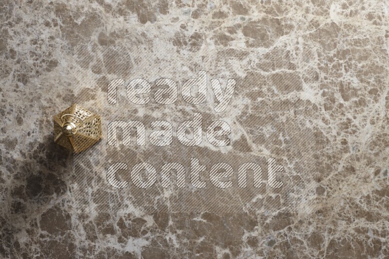 A lantern placed on a beige marble background
