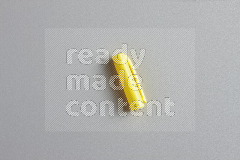 A close-up showing a single colored pen cap on grey background