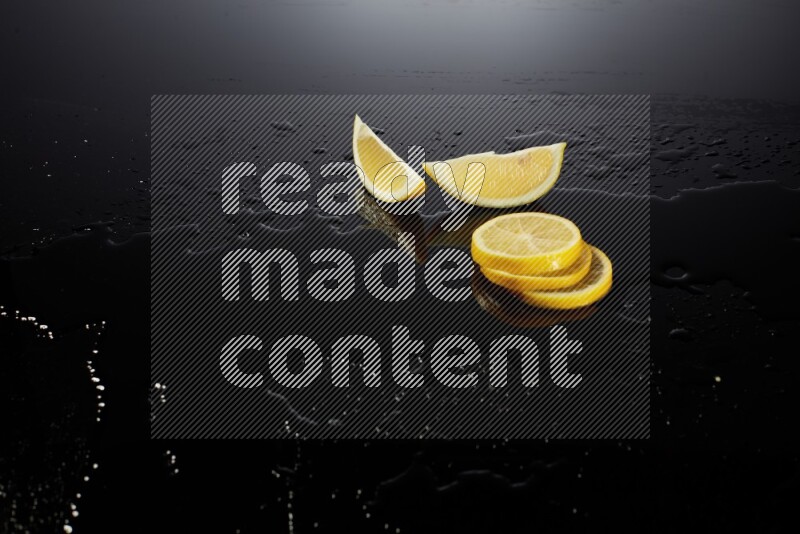 Lemon slices with water drops, and droplets on black background