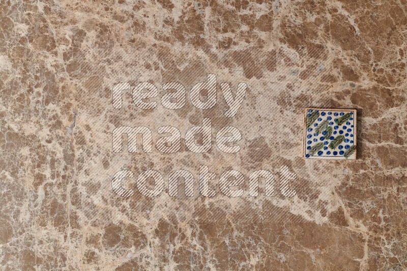 A decorative coaster on beige marble background