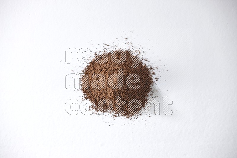 A pile of cloves powder on a white flooring