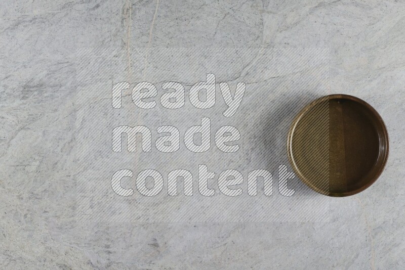 A multicolored pottery oven bowl on grey marble background