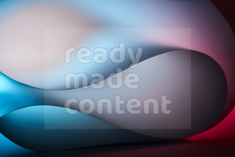 An abstract art piece displaying smooth curves in blue and red gradients created by colored light