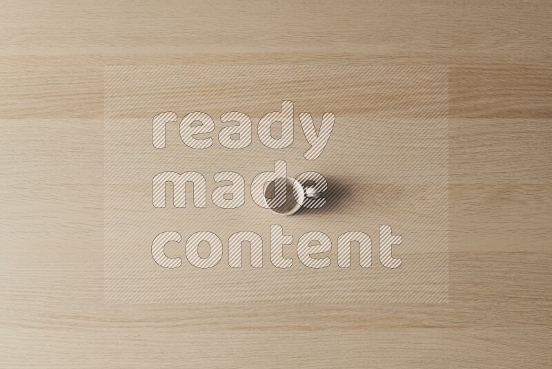 A pottery cup on light wooden background