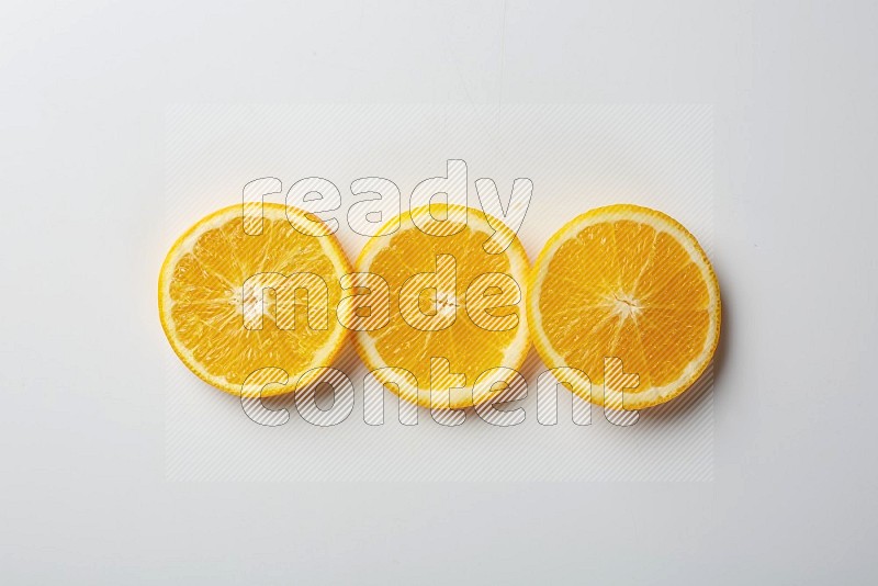 Three orange slices on a white background