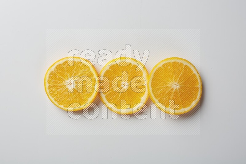 Three orange slices on a white background