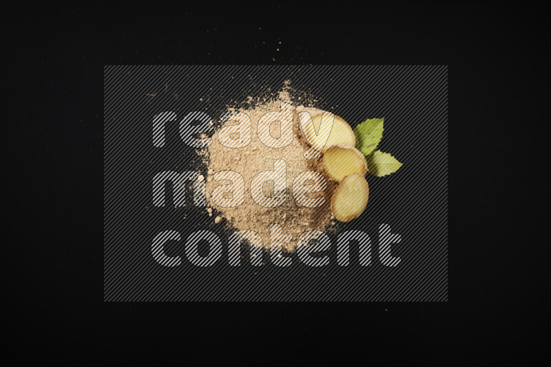 A bunch of ground ginger powder on black background