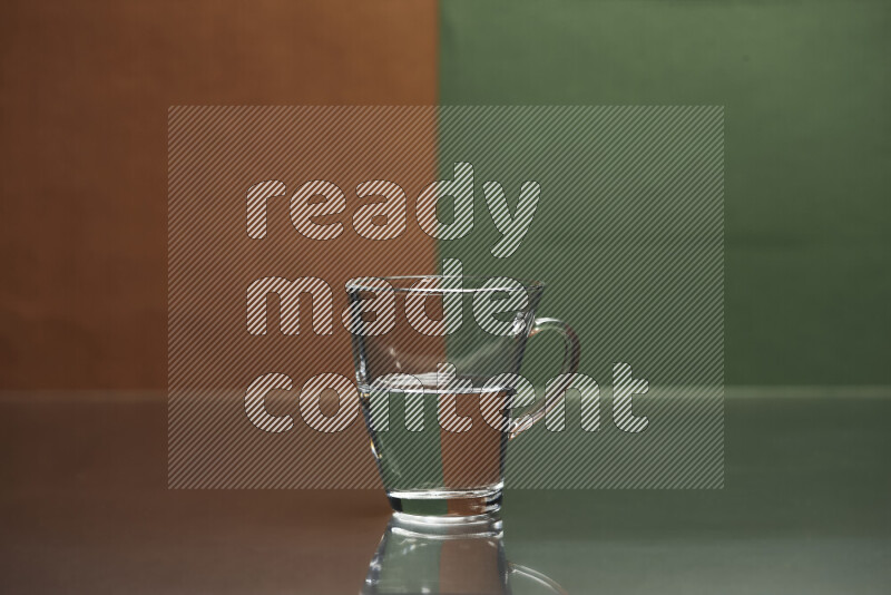 The image features a clear glassware filled with water, set against brown and dark green background