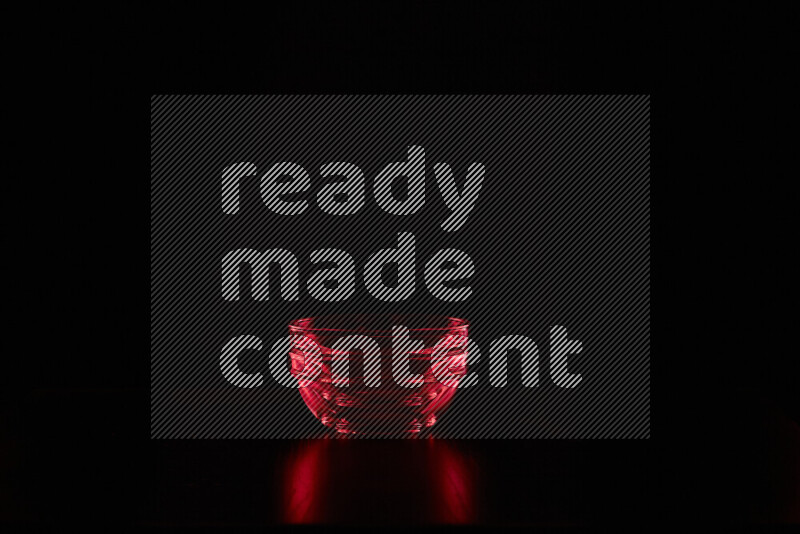 Glassware with rim light in red against black background