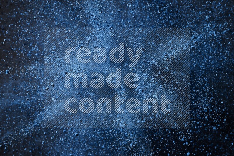 Blue powder explosion on black background