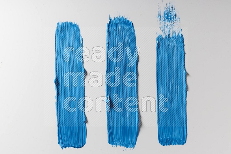 Blue painting brush strokes on white background