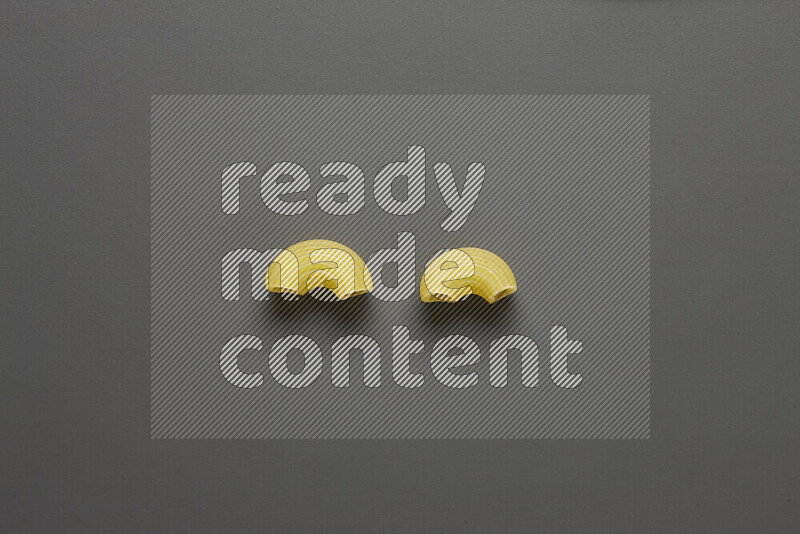 Elbow pasta on grey background