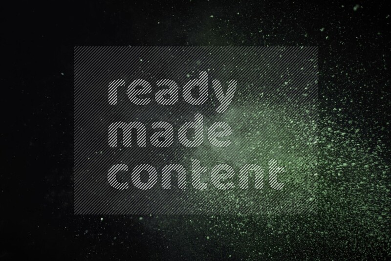 Green powder explosion on black background