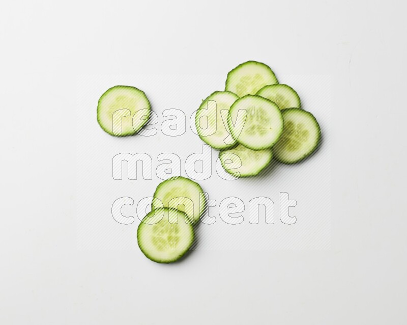Multiple cucumber slices on white background