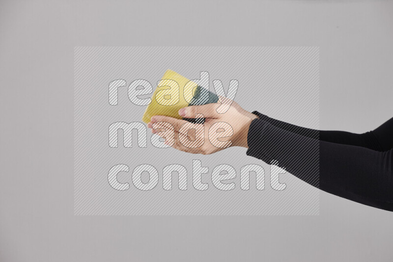 A woman in black abaya holding different pottery essentials in different positions