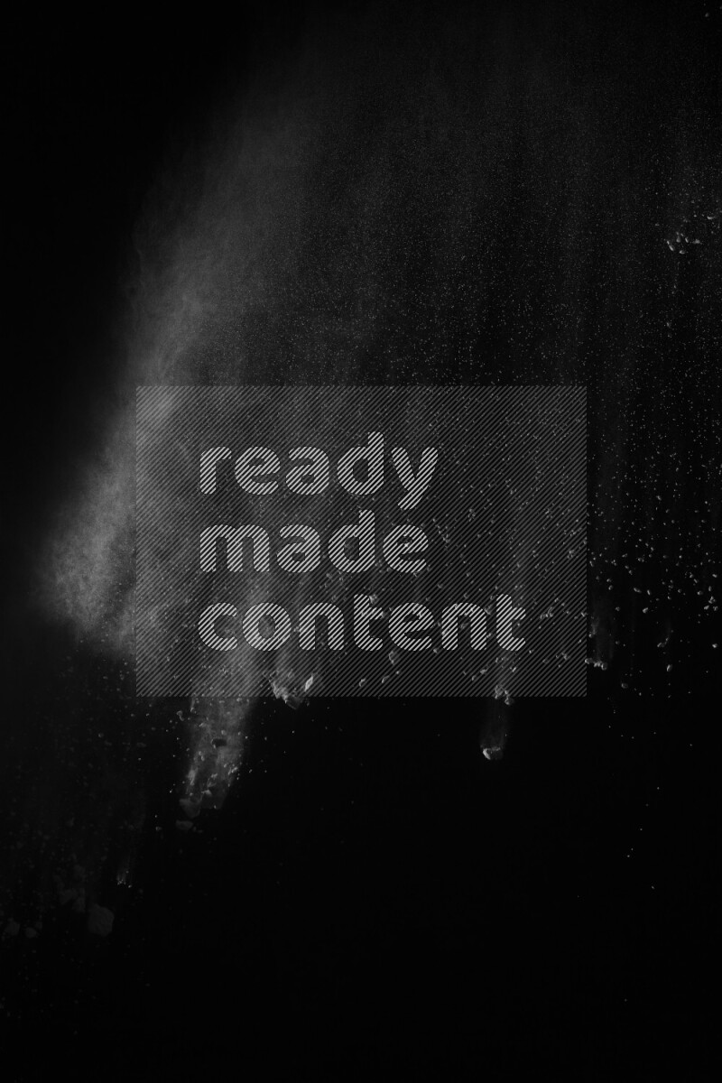 A side view of white powder explosion on black background
