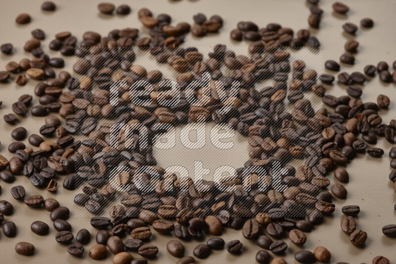 Roasted coffee beans on beige background