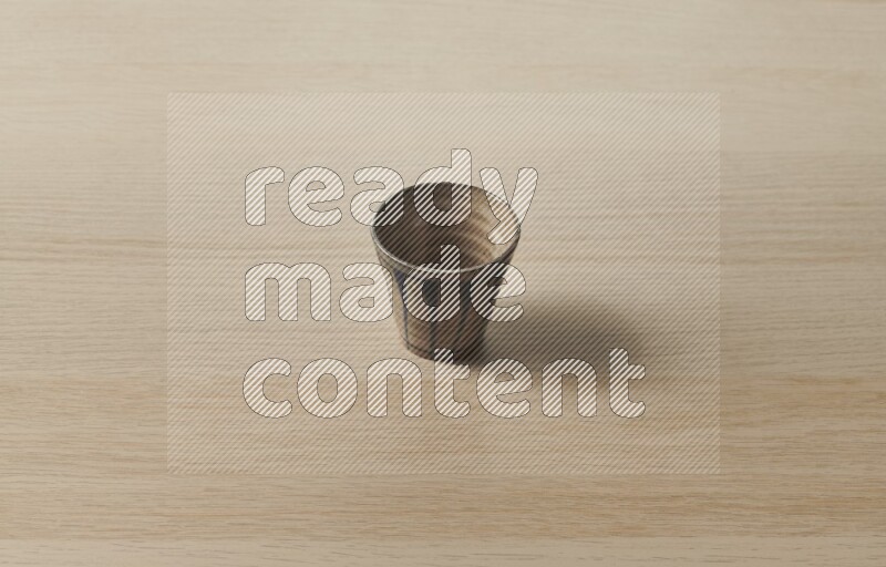 A pottery cup on light wooden background
