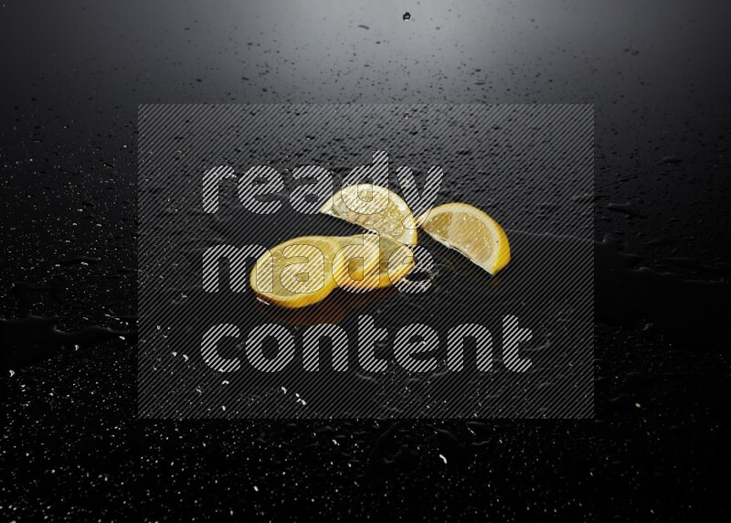 Lemon slices with water drops, and droplets on black background