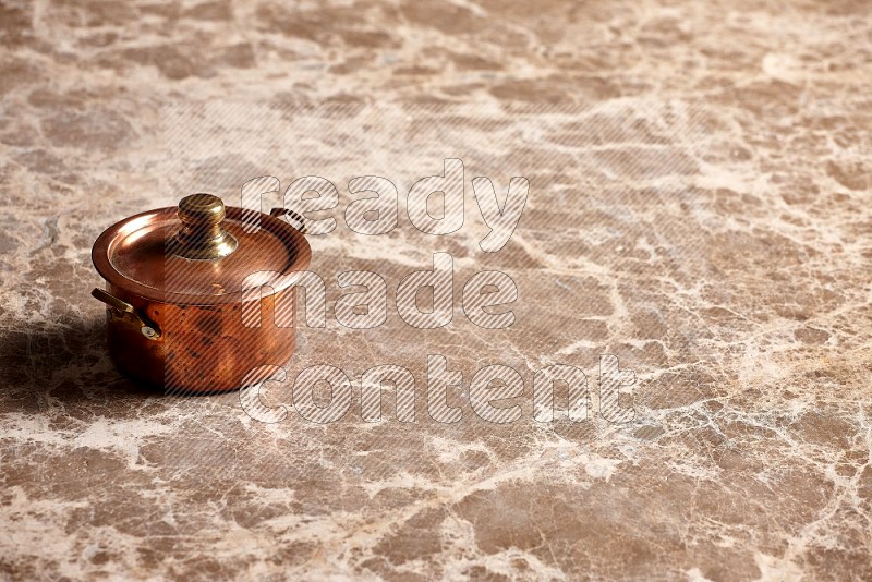 Small Copper Pot on Beige Marble Flooring, 45 degrees