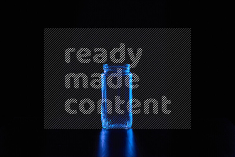 Glassware with rim light in blue against black background