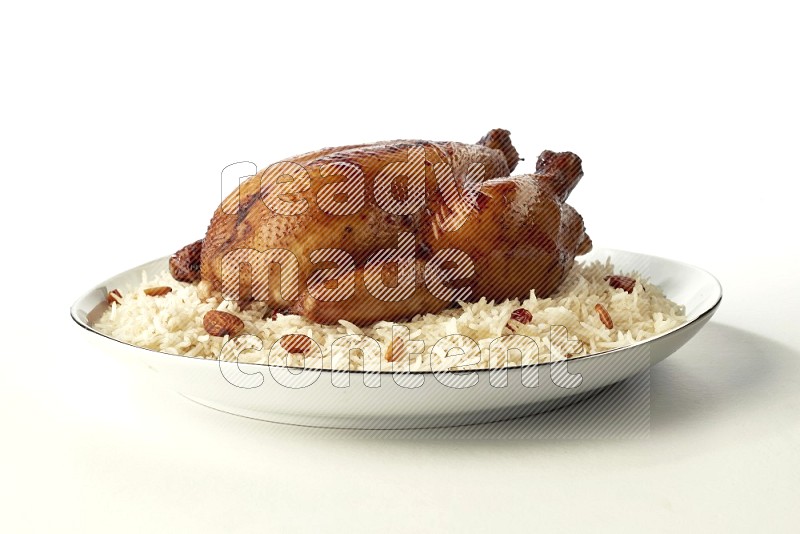 white  basmati Rice with  whole roasted chicken  on a white plate with a silver rim direct  on white background