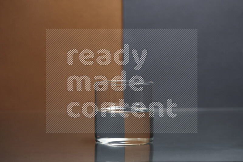 The image features a clear glassware filled with water, set against brown and dark blue background