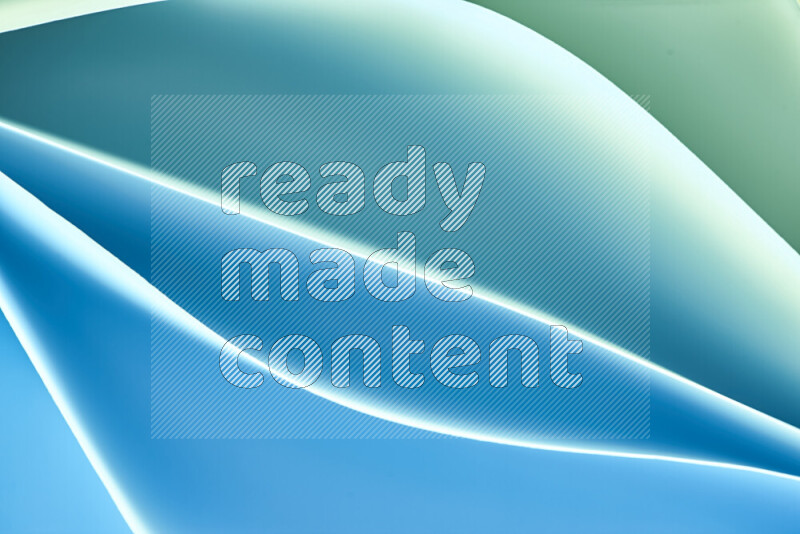 هذه الصورة تعرض تكوين فن الورق التجريدي مع منحنيات ورقية بتدرجات اللون الأخضر والأزرق المكونه بواسطة الضوء الملون