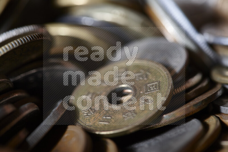 A close-ups of random old coins on black background
