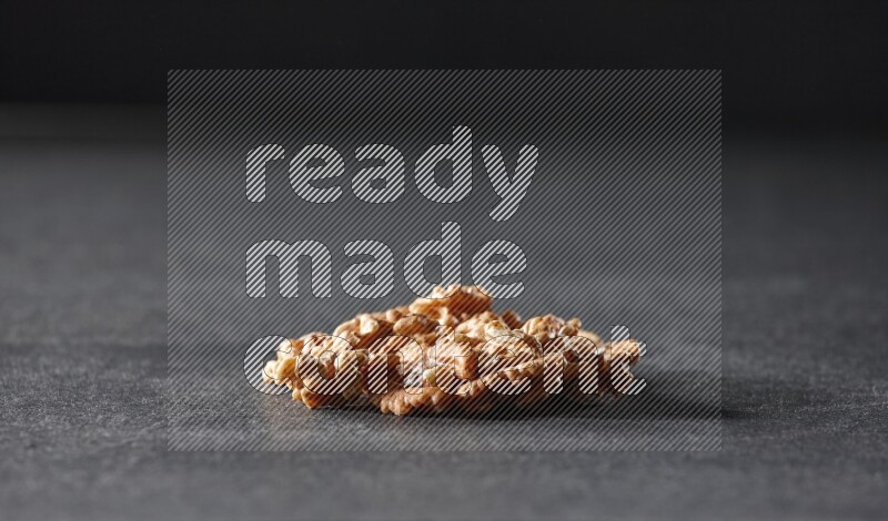 A bunch of walnuts on a black background in different angles