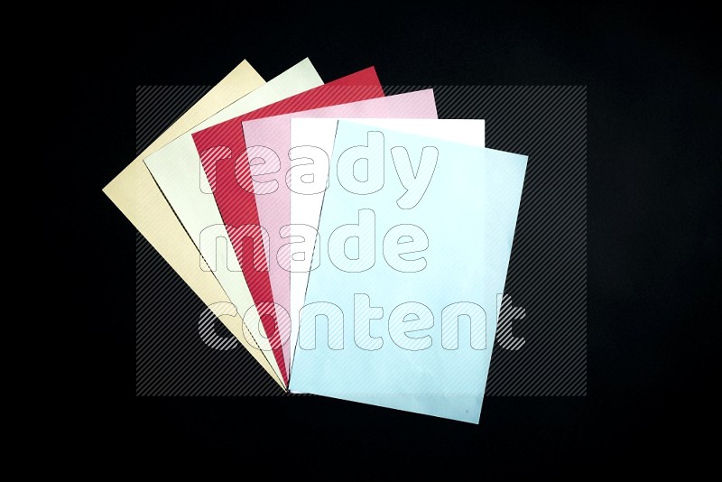 Multicolored paper sheet on black background