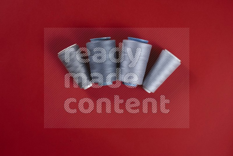Grey sewing supplies on red background