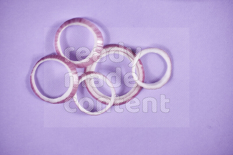 Red onions rings on purple background