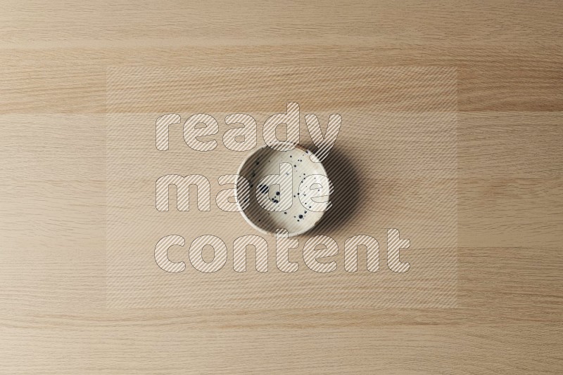 Top View Shot Of A Multicolored Pottery Bowl on Oak Wooden Flooring