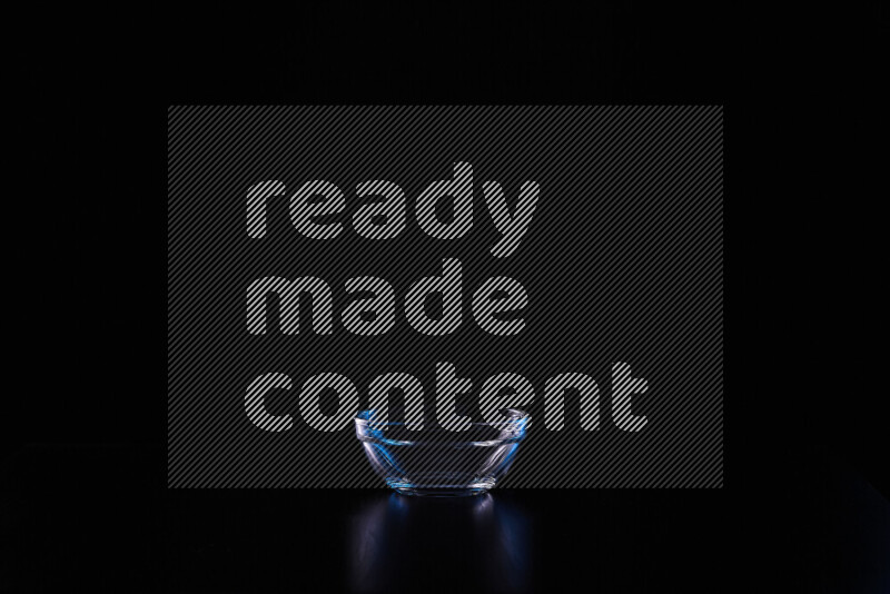 Glassware with rim light in blue and white against black background