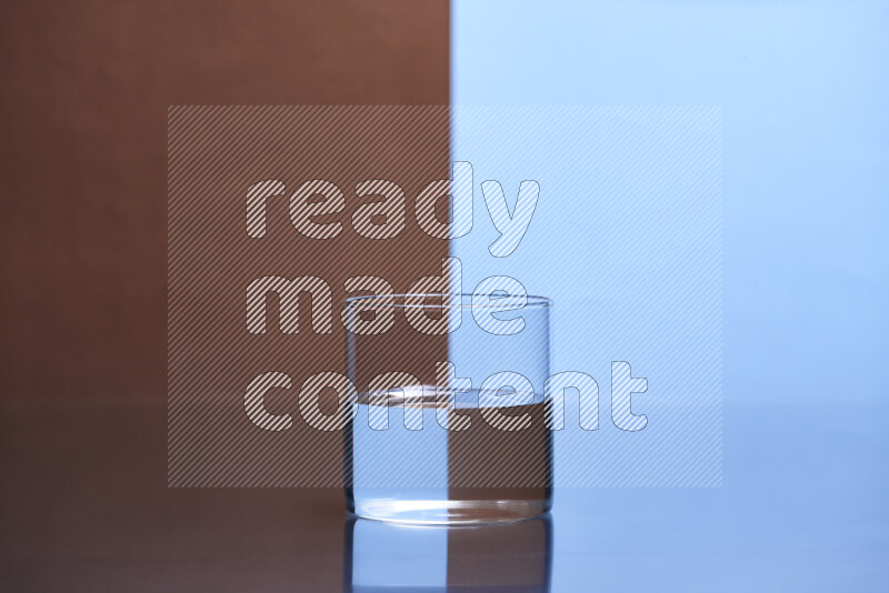 The image features a clear glassware filled with water, set against brown and light blue background