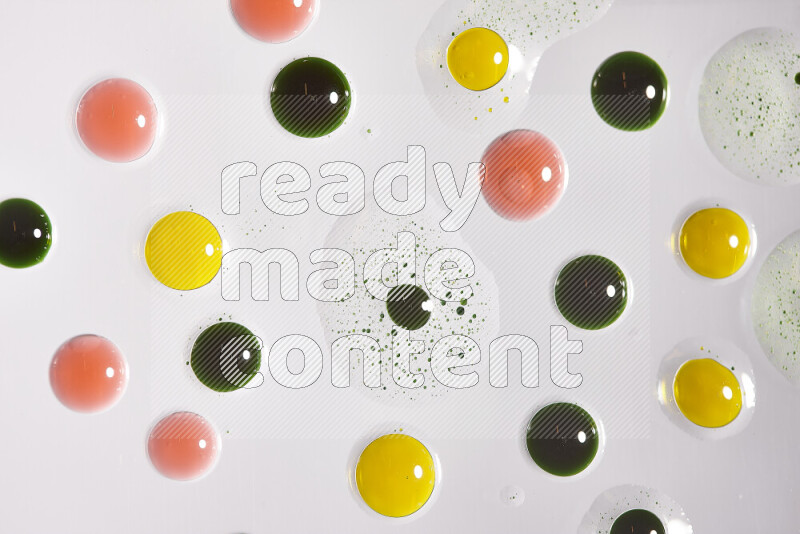 Close-ups of abstract green, yellow and red paint droplets on the surface