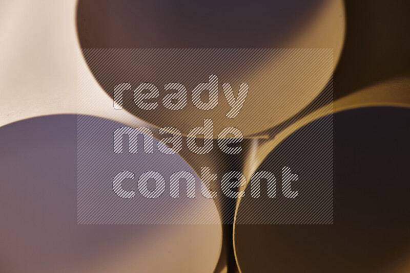 The image shows an abstract paper art with circular shapes in varying shades of grey and warm tones