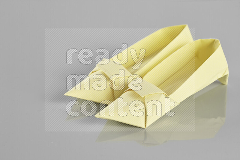 Origami shoes on grey background
