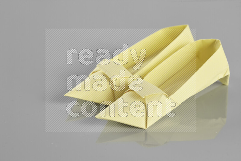 Origami shoes on grey background