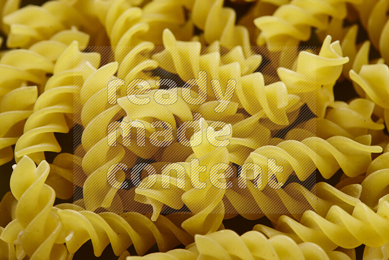 Fusilli pasta on grey background