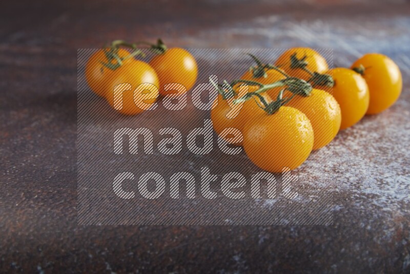Yellow cherry tomato vein on reddish rustic metal background 45 degree