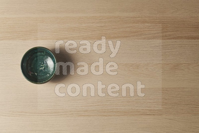 Top View Shot Of A Dark Green Pottery Bowl on Oak Wooden Flooring