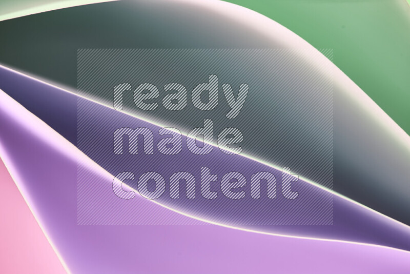 هذه الصورة تعرض تكوين فن الورق التجريدي مع منحنيات ورقية بتدرجات اللون الأخضر والوردي المكونه بواسطة الضوء الملون