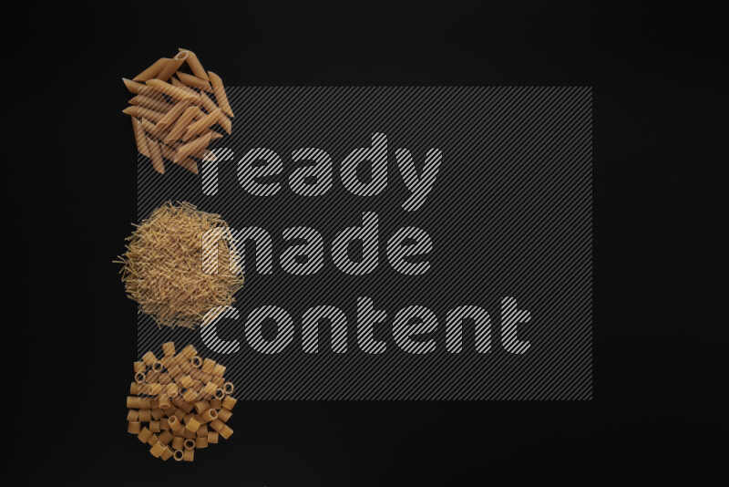 Different pasta types in 3 bunches on black background