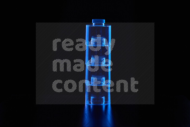 Glassware with rim light in blue against black background